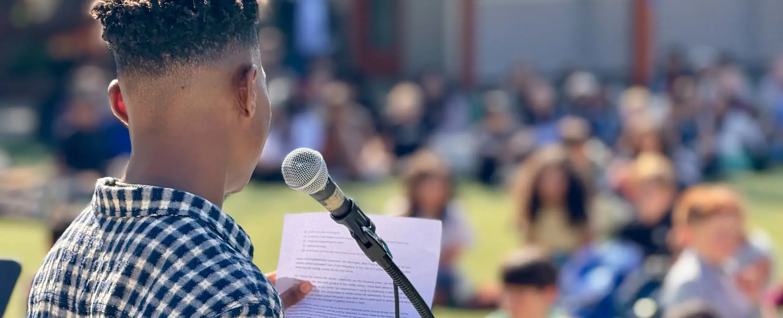 Boy speaking outdoor event
