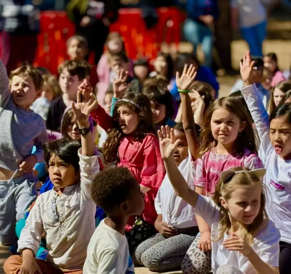 Students raising hands for activities