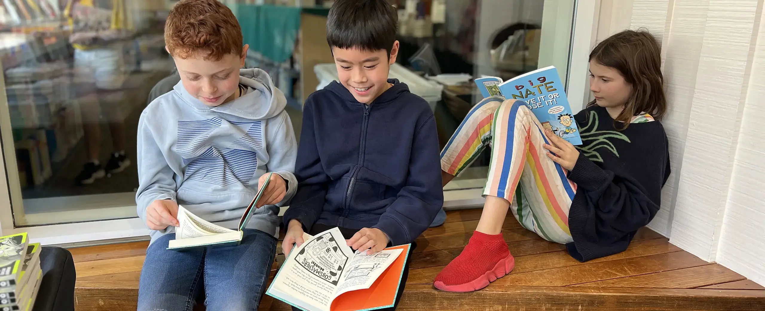 Kids reading on bench