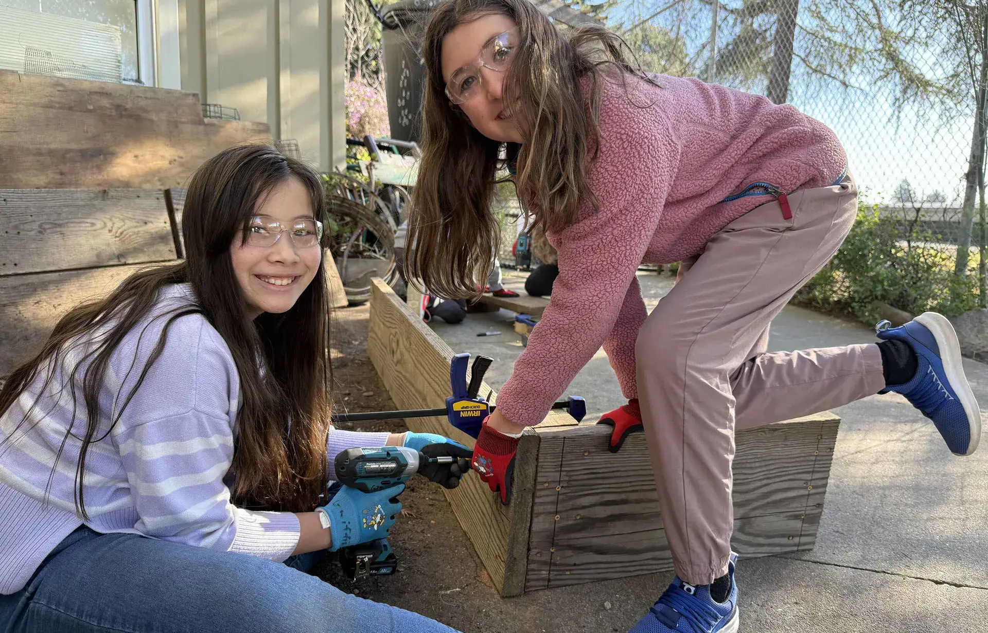 two girls working in garden